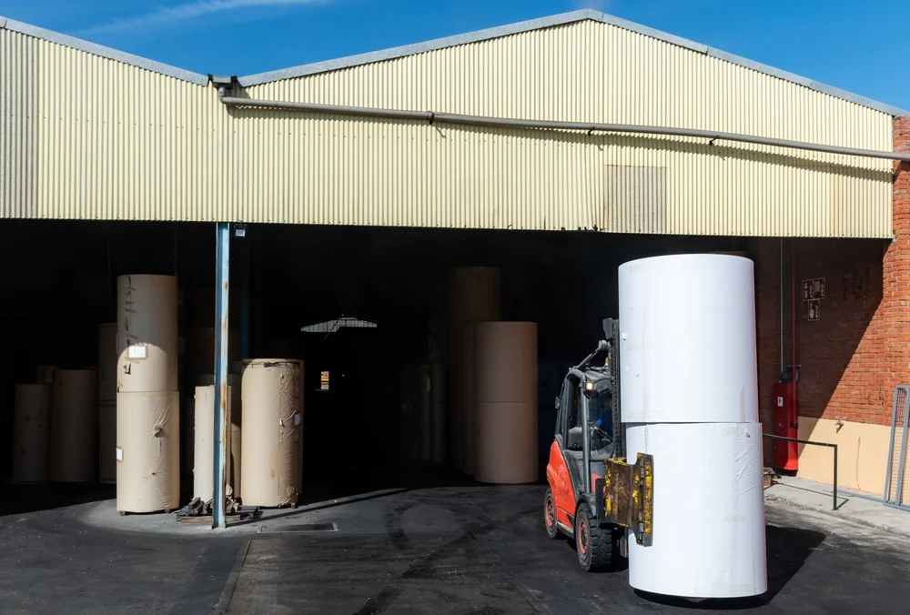 Forklift,With,Clamps,To,Move,Reels,Of,Paper,In,A Forklift paper Roll Clamps